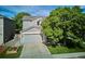 Charming two-story home with gray siding, an attached garage and well-maintained landscaping at 1169 S Alton Ct, Denver, CO 80247