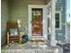 Inviting front porch with rocking chair, plants, and stylish decor at 1169 S Alton Ct, Denver, CO 80247