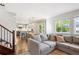 Open-concept living area with hardwood floors, a comfortable sofa, and bright natural light at 1169 S Alton Ct, Denver, CO 80247