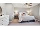 Bright main bedroom featuring a ceiling fan, neutral tones, and a comfortable queen bed at 1169 S Alton Ct, Denver, CO 80247