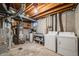 Unfinished basement with exposed beams, washer, dryer, and utility hookups at 12780 E Bethany Pl, Aurora, CO 80014