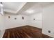 Finished basement room with dark wood laminate flooring and white walls at 12780 E Bethany Pl, Aurora, CO 80014