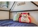 Close-up of a bed with a cute array of Squishmallow pillows with a DREAM sign on the wall at 12780 E Bethany Pl, Aurora, CO 80014