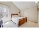 Bright bedroom featuring plush carpeting, a vaulted ceiling, and a light-filled window at 12780 E Bethany Pl, Aurora, CO 80014