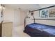Bedroom with black bedframe, large window, ample closet space and neutral carpet at 12780 E Bethany Pl, Aurora, CO 80014