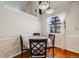 Cozy dining area featuring wood floors, modern lighting and a large window with sheer curtains at 12780 E Bethany Pl, Aurora, CO 80014