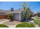 Well-maintained home with gray siding, stone chimney, neat landscaping, and a walkway at 12780 E Bethany Pl, Aurora, CO 80014
