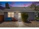 Twilight view of a charming single story home with stone chimney and cozy blue bench at 12780 E Bethany Pl, Aurora, CO 80014