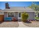 Charming single story home with stone chimney, walkway, and a cozy blue bench at 12780 E Bethany Pl, Aurora, CO 80014