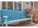Up close, cozy blue bench is complemented by attractive bushes and front window at 12780 E Bethany Pl, Aurora, CO 80014