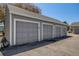 Detached garage with multiple parking spaces and light gray painted doors at 12780 E Bethany Pl, Aurora, CO 80014