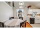 Bright kitchen and dining area illuminated by a window and modern lighting at 12780 E Bethany Pl, Aurora, CO 80014