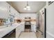 Charming kitchen featuring white cabinets, modern appliances, and stylish tile backsplash at 12780 E Bethany Pl, Aurora, CO 80014