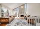 Bright living room with vaulted ceilings, a stone fireplace, and large windows with bright light at 12780 E Bethany Pl, Aurora, CO 80014