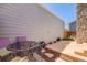 Back patio with table and chairs, stone fireplace feature, and privacy fence at 12780 E Bethany Pl, Aurora, CO 80014
