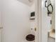 Bright powder room featuring a wood toilet seat, a unique plant shelf and neutral decor at 12780 E Bethany Pl, Aurora, CO 80014