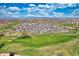 Panoramic aerial view of a neighborhood with lush green golf courses, mountain views, and abundant open space at 21229 E 50Th Ave, Denver, CO 80249