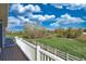 Back deck overlooking a spacious backyard with mature trees and white fencing, offering serene outdoor living at 21229 E 50Th Ave, Denver, CO 80249