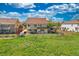 This home's backyard features a lush lawn, patio, and white picket fence at 21229 E 50Th Ave, Denver, CO 80249