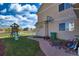 Spacious backyard with a play set, basketball hoop, charming walkway, and well-maintained lawn at 21229 E 50Th Ave, Denver, CO 80249