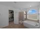Inviting bathroom with soaking tub, glass shower, and walk-in closet at 21229 E 50Th Ave, Denver, CO 80249