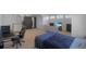 Inviting bedroom featuring a workspace, seating and a plush bed for relaxation at 21229 E 50Th Ave, Denver, CO 80249
