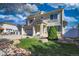Beautifully landscaped front yard with lush lawn, decorative rock accents, and a mature shade tree at 21229 E 50Th Ave, Denver, CO 80249