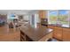 Open kitchen with a granite island and a sink with view of the combined living and dining area at 21229 E 50Th Ave, Denver, CO 80249