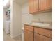 Functional laundry room with a utility sink, storage cabinets, and a washing machine at 21229 E 50Th Ave, Denver, CO 80249