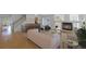 Open-concept living room with a fireplace, hardwood floors, and staircase at 21229 E 50Th Ave, Denver, CO 80249
