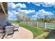 Inviting patio with comfortable seating, outdoor dining area, and a serene view of the expansive backyard at 21229 E 50Th Ave, Denver, CO 80249