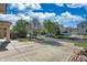 Street view showcasing a well-maintained home with mature trees, a spacious driveway, and neighborhood charm at 21229 E 50Th Ave, Denver, CO 80249