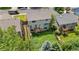Aerial shot showing the home's backyard, deck, and proximity to neighboring houses and mature trees at 4064 S Himalaya Way, Aurora, CO 80013
