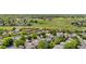 Wide aerial view of a residential neighborhood near a large park, highlighting the community's green spaces at 4064 S Himalaya Way, Aurora, CO 80013