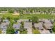 Aerial view of a neighborhood with mature trees, green spaces, and close proximity to a baseball field at 4064 S Himalaya Way, Aurora, CO 80013