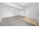 Finished basement featuring neutral carpet, access to a bathroom, and a storage area at 4064 S Himalaya Way, Aurora, CO 80013
