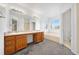 Bright bathroom featuring a double vanity, soaking tub, and walk-in shower at 4064 S Himalaya Way, Aurora, CO 80013