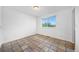 A clean bedroom showcases tiled floors, a window with natural light, and ample space for comfortable living at 4064 S Himalaya Way, Aurora, CO 80013