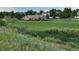 Community clubhouse with brick exterior, large windows, and a well-manicured lawn at 4064 S Himalaya Way, Aurora, CO 80013