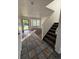 Inviting entryway with tile flooring that transitions to carpet, and staircase leads to the upper level at 4064 S Himalaya Way, Aurora, CO 80013
