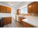 Kitchen featuring wood cabinets, tiled floors, and a bright window providing natural light, ready for your culinary creations at 4064 S Himalaya Way, Aurora, CO 80013
