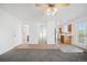 Inviting living room features plush carpeting and seamless transition to the kitchen, hallway, and exterior at 4064 S Himalaya Way, Aurora, CO 80013
