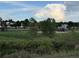 Scenic view of the community park with lush greenery and playground equipment at 4064 S Himalaya Way, Aurora, CO 80013