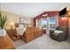 Well-lit bedroom featuring a king bed, accent wall, and comfortable seating area by the window at 3305 W 126Th Ave, Broomfield, CO 80020