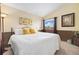 Comfortable bedroom with large window, yellow accent pillows, and soft carpet at 3305 W 126Th Ave, Broomfield, CO 80020