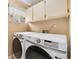 Laundry room featuring new front load washer and dryer with storage cabinets at 3305 W 126Th Ave, Broomfield, CO 80020