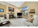 Inviting living room featuring a fireplace, plush seating, and a large window with a view of the outdoors at 3305 W 126Th Ave, Broomfield, CO 80020