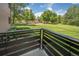 Balcony view of community playground with lush green grass and mature trees at 6505 Kalua Rd # 104B, Boulder, CO 80301