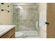Bathroom featuring decorative tile surround, glass shower doors, and upgraded fixtures at 6505 Kalua Rd # 104B, Boulder, CO 80301