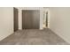 Bedroom with double closets and neutral carpeting, adjacent to the bathroom at 6505 Kalua Rd # 104B, Boulder, CO 80301